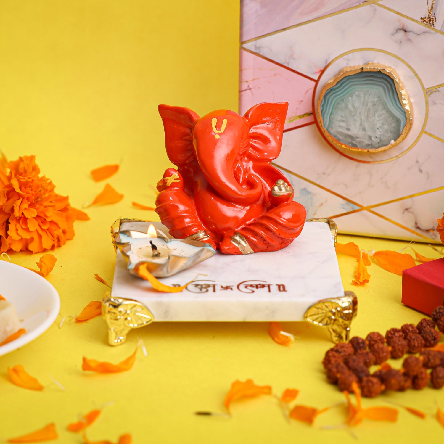 Orange Ganesha With Marble Choki And Candles